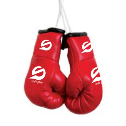 Realistic red mini boxing gloves with laces used for keychains car hanging décor or sports-themed gifting.